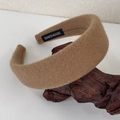 Detail of camel wool fabric headband featuring a white HANDMADE woven label on the inner side - Light Coffee
