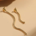 Elegant gold drop earrings with wavy design, clear rhinestones and relief face detail - Long Zirconia Drop