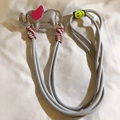 Close-up of a grey braided phone strap with a grey and pink cartoon elephant charm - Back Clip + Long Strap / Gray