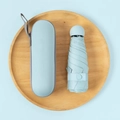 Light blue compact capsule umbrella with a matching portable hardshell carrying case - 6-Rib Mini Vinyl Thickened + Capsule Box / Light Blue