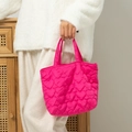 Detail view of pink quilted heart tote bag showing puffy texture and soft fabric handles - 27*10*18.5cm / Rose Red