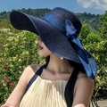 Women's wide brim navy blue straw sun hat with an elegant ribbon bow detail - One Size 55-60cm Adjustable / Navy Blue
