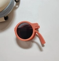 Foldable orange round kids sunglasses with grey lenses and a matching zipper storage case - Orange