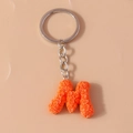 Fashionable orange letter M keychain featuring intricate rose flower textures and silver ring - Letter M