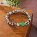 Beaded bracelet with white spotted beads and a green cross on a wood base - Black Red Green Spotted Green Cross Bracelet