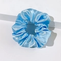 Detailed close-up of light blue satin scrunchie with silky texture and soft fabric folds - Sky Blue
