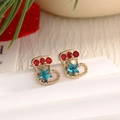 Festive gold-tone Christmas boot earrings with red and blue rhinestones on a holiday background - Rhinestone Christmas Boot (EAR0016)