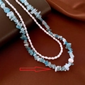 Detail of layered light blue stone and white rice pearl bracelet with baroque pearl accent - Blue Necklace