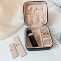 Inside view of black faux leather jewelry box with pink velvet lining and compartments - Black