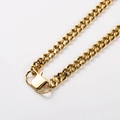 Golden stainless steel Cuban link chain necklace with secure clasp closure on white background - Gold Cuban Chain With Safety Clasp