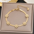 Gold titanium steel daisy bracelet with five flowers and heart charm on a brown box - Gold Daisy Five Flowers Style (5281)