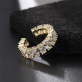 Detailed close-up of a gold-plated ring with oval cubic zirconia on a black velvet base - Gold Oval White Zircon Cuff Ring