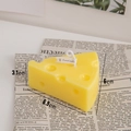 Cheese-shaped yellow scented candle with Swiss cheese holes and small branded tag - Small Cheese
