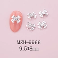 Detailed view of silver bow nail art charm with heart-shaped crystal on pink background - Silver Bow + Clear Heart Stone (9966)