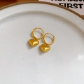 Golden heart pendant earrings with sparkling diamonds and pearls on a white plate - Gold Heart Brushed Style (HE24197-5)
