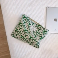 Detail of green floral canvas pouch with white leaves and Time to Party label on soft mat - Green Base Leaf