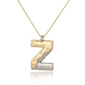 Macro view of two-tone golden and silver letter Z pendant with hammered metal texture - Letter Z