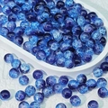 Macro detail of 10mm blue cracked glass beads with ice-flower texture for DIY jewelry - Black and Blue