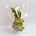 Close-up of green flocked Easter rabbit with beige ribbon in clear plastic packaging - Green (Height 22cm) Bagged