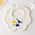 Soft cream-white cotton baby bib with cute dinosaur print and snap closure in a flat lay - Gauze Flower Wrap - Three Dinosaurs