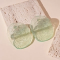 Detailed view of light green resin irregular earrings on a beige travertine stone - Light Green