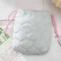 Detail of light blue quilted drawstring bag with pink tassels for polaroid cameras - Quilted Gourd Blue