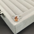 Elegant 925 sterling silver ring with oval orange gemstone and sparkling accents - Size 5 / Champagne
