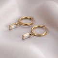 Elegant gold hoop earrings with a rectangular clear zircon pendant on silk background - 14K Gold White Zirconia