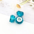 Three blue faceted acrylic large hole barrel beads with silver metal cores on wood - Lake Blue