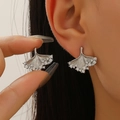 Elegant silver ginkgo leaf stud earrings with sparkling diamonds on model - Silver Zirconia Ginkgo Leaf Stud Earrings (11493)