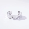Detailed close-up of a silver irregular textured wide open cuff bangle on white background - Hammered Finish / Silver