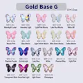 Cuadrícula de dijes de mariposa de cristal para uñas en 22 colores con bases doradas - Base Dorada / Brillo de Luna Blanca