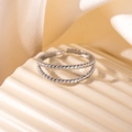 Detailed view of silver double-layered bead ring on a beige wavy ceramic display stand - Steel Color 41