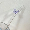 Heat-resistant glass straw featuring a delicate purple butterfly ornament on top - Purple