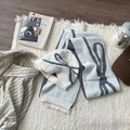 Blue knitted winter set featuring beanie and scarf with dark grey bow patterns - Off-white Set