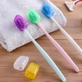 Portable toothbrush head covers in multiple colors on a wooden surface with a grey towel - Bulk Toothbrush Head Covers