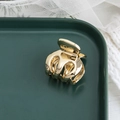 Elegante pinza per capelli in metallo dorato su vassoio in ceramica verde e fondo in tessuto - Oro