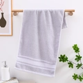 Lavender cotton towel with white chevron stripes hanging in a minimalist bathroom - Grey Large Arrow Pattern