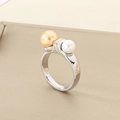 Macro detail of geometric silver ring featuring a gold and white pearl on metal tray - US 6 / Steel Color Two-Tone Pearl Simple Style (KR111170-K)