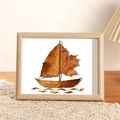 Light wood frame featuring handmade leaf collage boat art on white woven tablecloth - 5 Inch / Oak