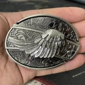 Detailed close-up of oval belt buckle with antique silver wings relief carving - Angel Wing