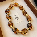 Detail of tortoise shell resin chain necklace with golden metal links on a tray - 37# Necklace - Gold - Brown Pig Nose Thick Chain