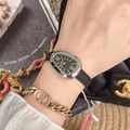 Women's watch with silver oval case and black textured leather strap on wrist - Silver Case Black Dial Black Strap