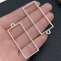 Silver rectangular alloy frame pendant charm for DIY jewelry making on leather background - Rectangle Bezel (22249) / 48x20mm / Bright Silver