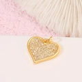 Macro shot of 14K gold-plated heart pendant with faceted colorful zircon stones - Pave Heart Pendant