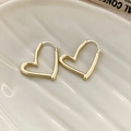 Minimalist gold heart hoop earrings with a polished mirror finish on a ceramic plate - Gold Heart Hoop (66#)