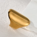 Detailed close-up of a wide irregular gold stainless steel ring on a textured surface - Wide Irregular Style (JZR738-C)