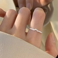 Close-up of minimalist 925 silver wavy ring with heart detail on female model's finger - Heart Wave Minimalist Thin Style(JZ0621)