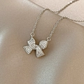 Silver bow pendant necklace featuring pavé-set stones on champagne satin background - Titanium Steel Silver Style (X493)