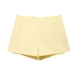 Detail of high-waisted pale yellow casual shorts with side pockets and smooth fabric - XS / Yellow Shorts